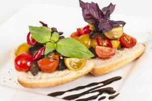 sappige tomaten op vers brood, pesto als topping foto