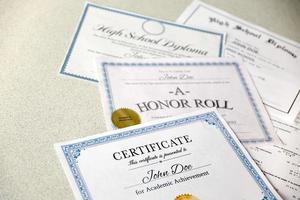 een eer rollen herkenning, certificaat van prestatie en hoog school- diploma leugens Aan tafel. onderwijs documenten foto