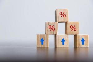 detailopname hout kubussen met percentage symbool, procent en omhoog toenemend pijlen Aan houten kubussen. financieel interesseren hypotheek tarieven toenemen of prijs commissie salarisverhoging, groei bedrijf, financiën belasting. foto