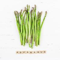 vers groen asperges Aan wit houten achtergrond foto