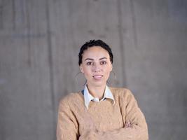 portret van gewoontjes zakenvrouw in voorkant van een beton muur foto
