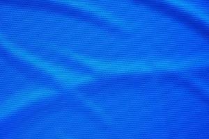 blauw Amerikaans voetbal Jersey kleding kleding stof structuur sport- slijtage achtergrond, dichtbij omhoog top visie foto