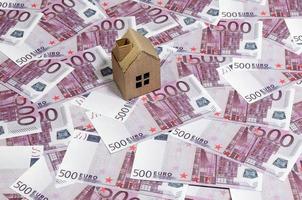 hoog hoek visie van een karton speelgoed- huis Aan 500 euro notities. geld van euro voor aankoop van de privaat huis. hypotheek concept foto