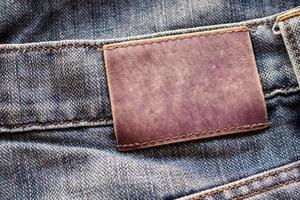 blauw denim jeans leer etiket structuur achtergrond foto