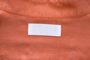 wit blanco kleding label etiket Aan linnen overhemd kleding stof structuur achtergrond foto