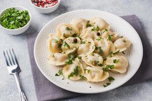 traditioneel pelmeni, ravioli, knoedels gevulde met vlees Aan bord, Russisch keuken foto