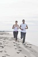 paar jogging Aan de strand foto