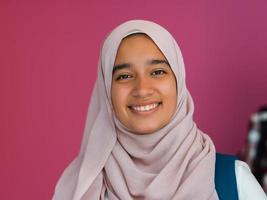 een groep van Arabisch tieners, een leerling team wandelen vooruit in de toekomst en terug naar school- de concept van een roze achtergrond. de concept van geslaagd onderwijs voor jong mensen. selectief focus foto