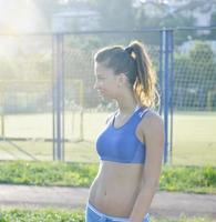 gelukkig jong vrouw Aan atletisch ras bijhouden foto