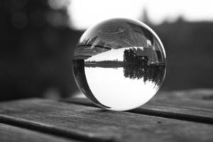 glas bal Aan een houten pier Bij een Zweeds meer Bij schemer in zwart en wit. natuur foto