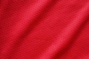 rood sport- kleding kleding stof Amerikaans voetbal overhemd Jersey structuur dichtbij omhoog foto