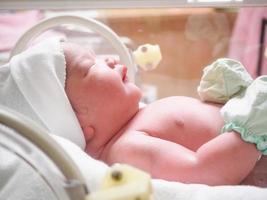 nieuw geboren baby zuigeling slaap in de incubator Bij ziekenhuis foto