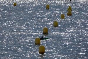 geel markeerstift boeien in de zee naar aangeven de passage van schepen foto