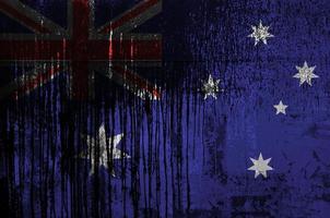 Australië vlag afgebeeld in verf kleuren Aan oud en vuil olie vat muur detailopname. getextureerde banier Aan ruw achtergrond foto