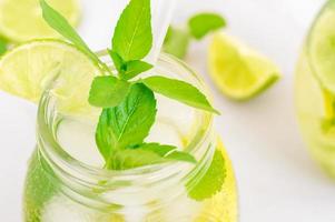 citroen limonade in metselaar pot glas gemaakt van fruit Aan een tafel achtergrond. verkoudheid zomer drank. mojito cocktail met citroen en munt. foto