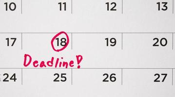 deadline schrijven Aan wit kalender bladzijde datum dichtbij omhoog foto
