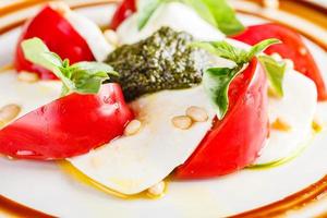 caprese salade met Mozzarella, tomaat, basilicum en pesto foto