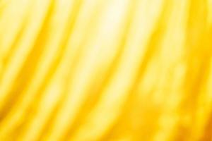 geel bed linnen helling structuur wazig kromme stijl van abstract luxe stof, gerimpeld bed linnen en goud schaduwen, achtergrond foto