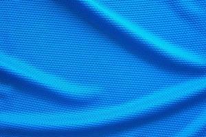 blauw Amerikaans voetbal Jersey kleding kleding stof structuur sport- slijtage achtergrond, dichtbij omhoog top visie foto