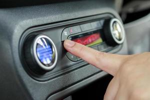 vrouw hand- beurt Aan auto lucht conditioning systeem foto