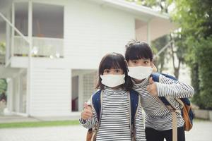 school- kind vervelend een gezicht masker gedurende coronavirus en griep uitbraak. weinig meisje gaan terug naar school- na covid-19 quarantaine en lockdown. foto