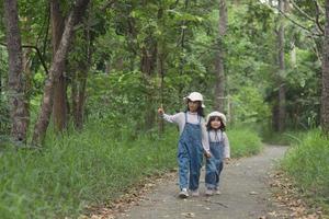 kinderen zijn rubriek naar de familie camping in de Woud wandelen langs de toerist route. camping weg. familie reizen vakantie concept. foto