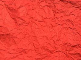 rood verfrommeld papier structuur achtergrond voor ontwerp. behang voor kopiëren ruimte foto