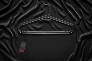 zwart hanger dat hebben prijs label met woord Aan zwart kleding achtergrond. zwart vrijdag concept. foto