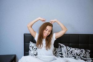 mooi Kaukasisch vrouw Bij huis in bed ontspannende foto