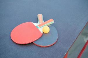 rackets en bal Aan ping pong tafel in buitenshuis sport tuin. actief sport- en fysiek opleiding concept foto