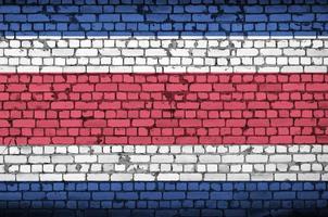 costa rica vlag is geschilderd op een oud steen muur foto