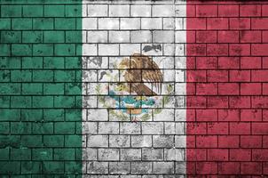 Mexico vlag is geschilderd op een oud steen muur foto