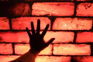 hand- aanraken de verlichte dun khewra zout plakjes in Pakistan foto