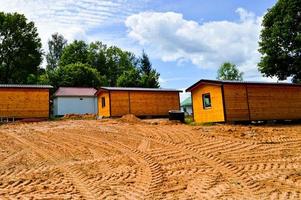 bouw van klein geel houten kader geprefabriceerd geprefabriceerd eco-huis van buitenwijk modulair snelgroeiend huizen, gebouwen, huisjes. industrieel bouwen foto