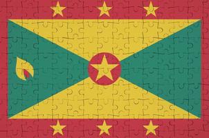 Grenada vlag is afgebeeld Aan een gevouwen puzzel foto