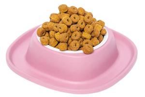droog voedsel voor huisdieren. evenwichtig voeden voor katten en honden in een roze schaal. foto