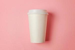 eenvoudig vlak leggen ontwerp papier koffie kop Aan roze pastel kleurrijk modieus achtergrond. meenemen drinken container. mooi zo ochtend- wakker worden omhoog wakker concept. sjabloon van drinken model. top visie kopiëren ruimte. foto