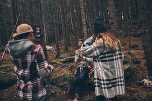niets is beter dan oud vrienden. groep van gelukkig jong mensen uitgeven tijd samen terwijl wandelen in de bossen foto