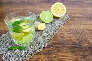 biologische ginger ale frisdrank in een glas met citroen en limoen foto