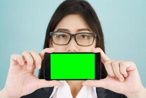 Dames Holding smartphone bespotten omhoog groen scherm foto