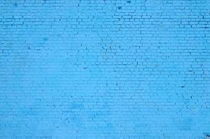 plein steen blok muur achtergrond en textuur. geschilderd in blauw foto