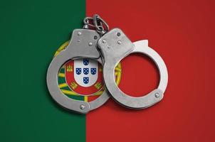 Portugal vlag en Politie handboeien. de concept van naleving van de wet in de land en bescherming van misdrijf foto