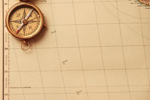 antiek koperen kompas over oude kaart