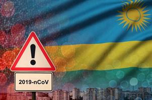 rwanda vlag en coronavirus 2019-ncov alarm teken. concept van hoog waarschijnlijkheid van roman coronavirus het uitbreken door op reis toeristen foto