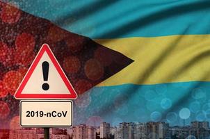 Bahamas vlag en coronavirus 2019-ncov alarm teken. concept van hoog waarschijnlijkheid van roman coronavirus het uitbreken door op reis toeristen foto