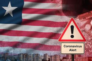 Liberia vlag en coronavirus 2019-ncov alarm teken. concept van hoog waarschijnlijkheid van roman coronavirus het uitbreken door op reis toeristen foto