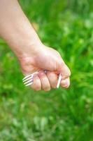 hand- van een weinig meisje Holding plastic uitschot foto