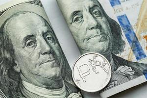 Russisch een roebel munten en Verenigde Staten van Amerika een honderd dollar bankbiljetten foto