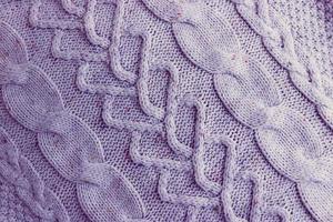 mooi structuur van een zacht warm natuurlijk trui met een gebreid patroon van draden. de achtergrond foto