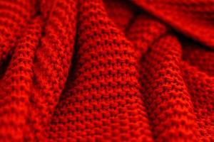 structuur van rood gebreid kleding stof dichtbij omhoog. wol Jersey. foto